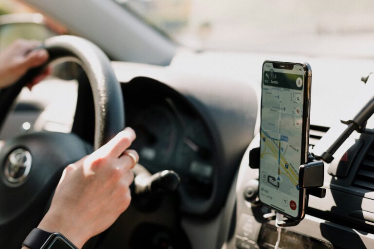 Driver using Google Maps navigation on a smartphone, representing how businesses can improve visibility through Google Maps business listings.