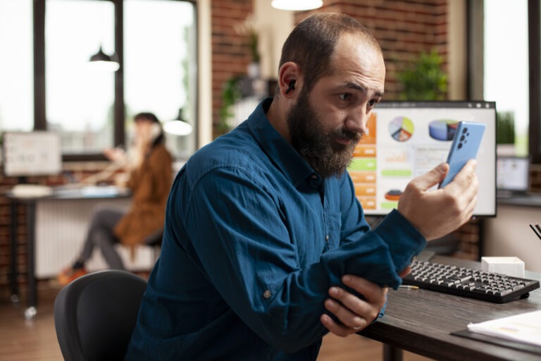 Business owner checking Google Business Profile rankings and local search visibility on a mobile device.